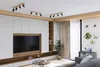 A modern living room with a large TV, built-in shelving, and decorative elements. Produktbild-Vorschau