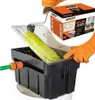 A person's hands in orange gloves are shown using a paint roller cleaning device. The device is black with a clear lid and a green roller. A box with the brand name MOTIVE is visible in the background. Náhled obrázku produktu