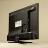 The back of a Telefunken television is shown, angled to the right, with its stand attached. Produktbild-Vorschau