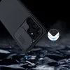A black phone case with a camera cover is shown falling onto a rocky surface, with a small circular graphic highlighting the case's protective features. Anteprima dell’immagine prodotto