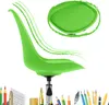 A bright green office chair is shown against a white background, with artistic green brush strokes emanating from it. Below the chair, a collection of art and writing supplies is visible. Voir les images du produit