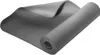 A gray yoga mat is partially unrolled on a white background.