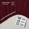 A close-up of a burgundy fabric with text and care symbols. Produktbild-Vorschau