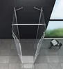 A top-down view of a glass shower enclosure with silver metal framing, set against a tiled floor and dark tiled wall, with a window showing a blurred outdoor scene. Produktbild-Vorschau