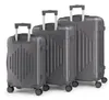 Three gray suitcases of different sizes are arranged in a row against a white background.
