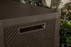 A close-up view of a brown storage box with a textured surface and a handle. Podgląd zdjęcia produktu