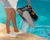 A person is holding a pool cleaning robot out of a swimming pool. Produktbild-Vorschau