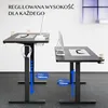 Two standing desks are shown in a studio setting. One desk is closer and shows headphones hanging from the side. The other desk is further away. Text overlays indicate adjustable height. Podgląd zdjęcia produktu