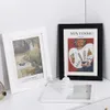 Two framed pictures are displayed on a white surface, with a small decorative jar in the foreground. Náhľad obrázku produktu