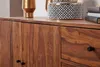 A close-up view of a wooden sideboard with decorative items on top. Náhled obrázku produktu