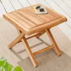 A wooden side table on a rug with a wooden deck in the background. Produktbild-Vorschau