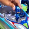 A child's hand places a toy figure into a toy vehicle. Produktbild-Vorschau