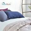 A bed with several pillows and a duvet. Produktbild-Vorschau