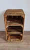 A wooden crate shelf unit on a wooden floor against a white wall. Produktbild-Vorschau