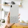A hand holding a phone case with glitter. Produktbild-Vorschau