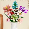A close-up shot of a colorful bouquet of artificial flowers in a white vase. Produktbild-Vorschau