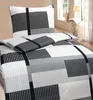 A bed with a duvet and pillow in a geometric pattern. Produktbild-Vorschau