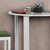 A close-up view of a white desk with a laptop, a mug, and a pen holder. Anteprima dell’immagine prodotto