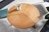 A round wooden coffee table with a black metal frame, viewed from above. Produktbild-Vorschau