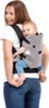 A woman is carrying a baby in a baby carrier on her back. Podgląd zdjęcia produktu