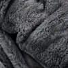 A close-up view of a dark gray, fluffy material, likely faux fur. Produktbild-Vorschau