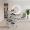 A modern bedroom or dressing room with a closet, a vanity, a chair, and a plant. A rolling cart with shelves is in the foreground. Voir les images du produit