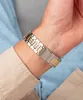 Close-up of a man's wrist wearing a two-tone watch. Podgląd zdjęcia produktu