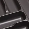 A close-up view of a dark gray plastic cutlery organizer with textured compartments. Produktbild-Vorschau