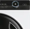 A close-up view of the control panel and drum of a washing machine. Produktbild-Vorschau