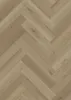 A close-up, top-down view of a herringbone-patterned vinyl flooring. Produktbild-Vorschau