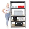 A woman stands next to a black metal shelving unit filled with various storage containers. Produktbild-Vorschau