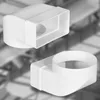 Two white plastic ventilation duct connectors are shown against a blurred background. Podgląd zdjęcia produktu