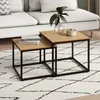 A living room scene with a couch, rug, and nesting coffee tables. Produktbild-Vorschau