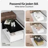 A collage showing different color options of a modern coffee table. The main image on the left shows a black and white coffee table. The right side shows three smaller images of the same coffee table in different color variations: white, white with wood ac Produktbild-Vorschau