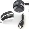 A close-up of black and white headphones with a charging cable. Produktbild-Vorschau