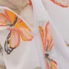 A close-up view of a white fabric with a painted butterfly pattern and a zipper. Produktbild-Vorschau