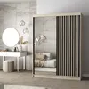 A bedroom scene featuring a wardrobe with mirrored and slatted doors, a vanity table with a round mirror, and decorative lighting. Náhled obrázku produktu