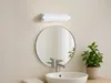 A bathroom vanity with a sink, faucet, mirror, and a wall-mounted light fixture. Náhled obrázku produktu
