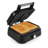 A close-up, high-angle shot of a black waffle maker with two freshly cooked waffles inside, against a plain white background. Produktbild-Vorschau