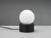A minimalist black and white table lamp with a spherical white shade sits on a light gray surface against a dark gray background. Produktbild-Vorschau