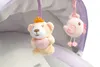 Close-up of two plush toys hanging from a canopy. Produktbild-Vorschau