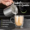 Pouring milk foam into a coffee cup. Produktbild-Vorschau