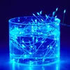 A glass container filled with water and illuminated by blue LED string lights. Produktbild-Vorschau