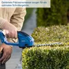 A person is using a cordless hedge trimmer to trim a bush. Produktbild-Vorschau