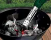A charcoal lighter is being used to ignite charcoal in a grill. Produktbild-Vorschau