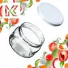 A glass jar and its lid are shown with a decorative border of fresh vegetables and herbs. Podgląd zdjęcia produktu