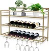A gold-colored wine rack with bottles and glasses on shelves, with plants on the top shelf. Podgląd zdjęcia produktu