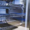 Close-up view of the interior shelves of a refrigerator or storage unit. Anteprima dell’immagine prodotto