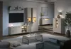 A modern living room with a TV, media console, coffee table, and accent cabinets. Voir les images du produit