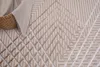 A close-up view of a textured rug with a geometric pattern. Produktbild-Vorschau